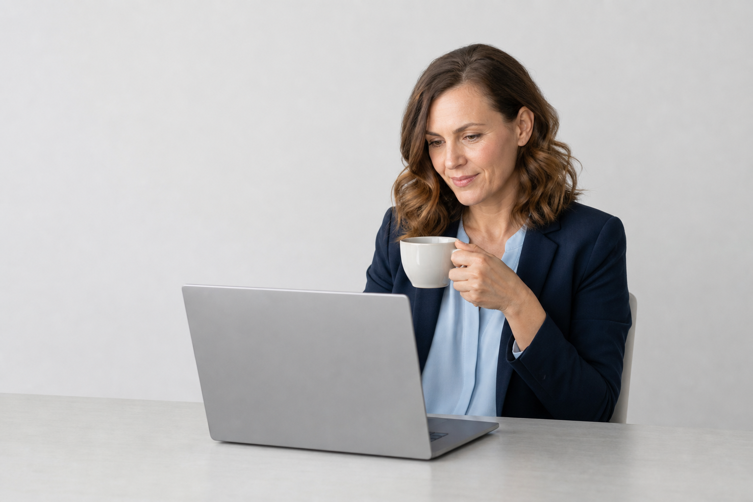 A manager reading an Atlas-prepared briefing on her laptop